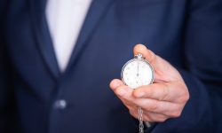 Clock in businessman hand. Deadline, time management problem concept.