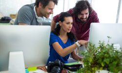 Team of graphic designers working at desk in office